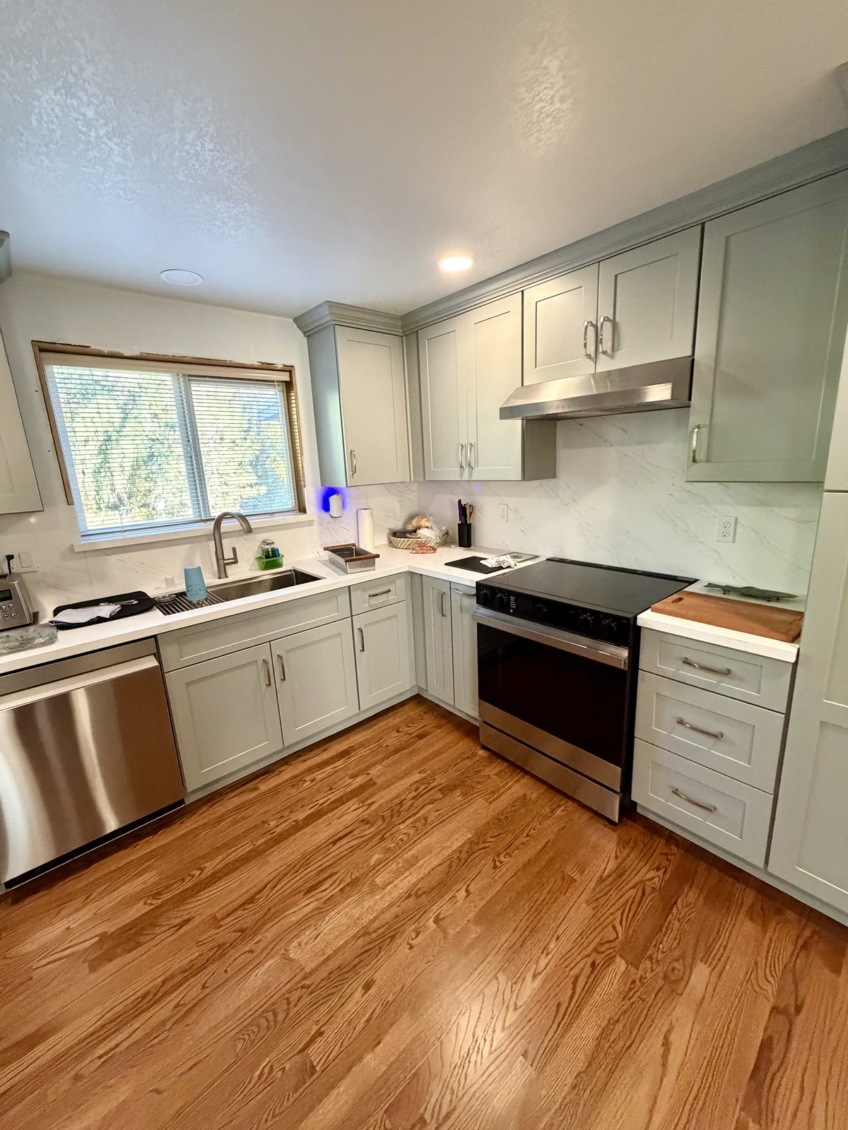 New cabinets and quartz along the range wall. Kitchen remodel in Lacey by DA Interior Solutions
