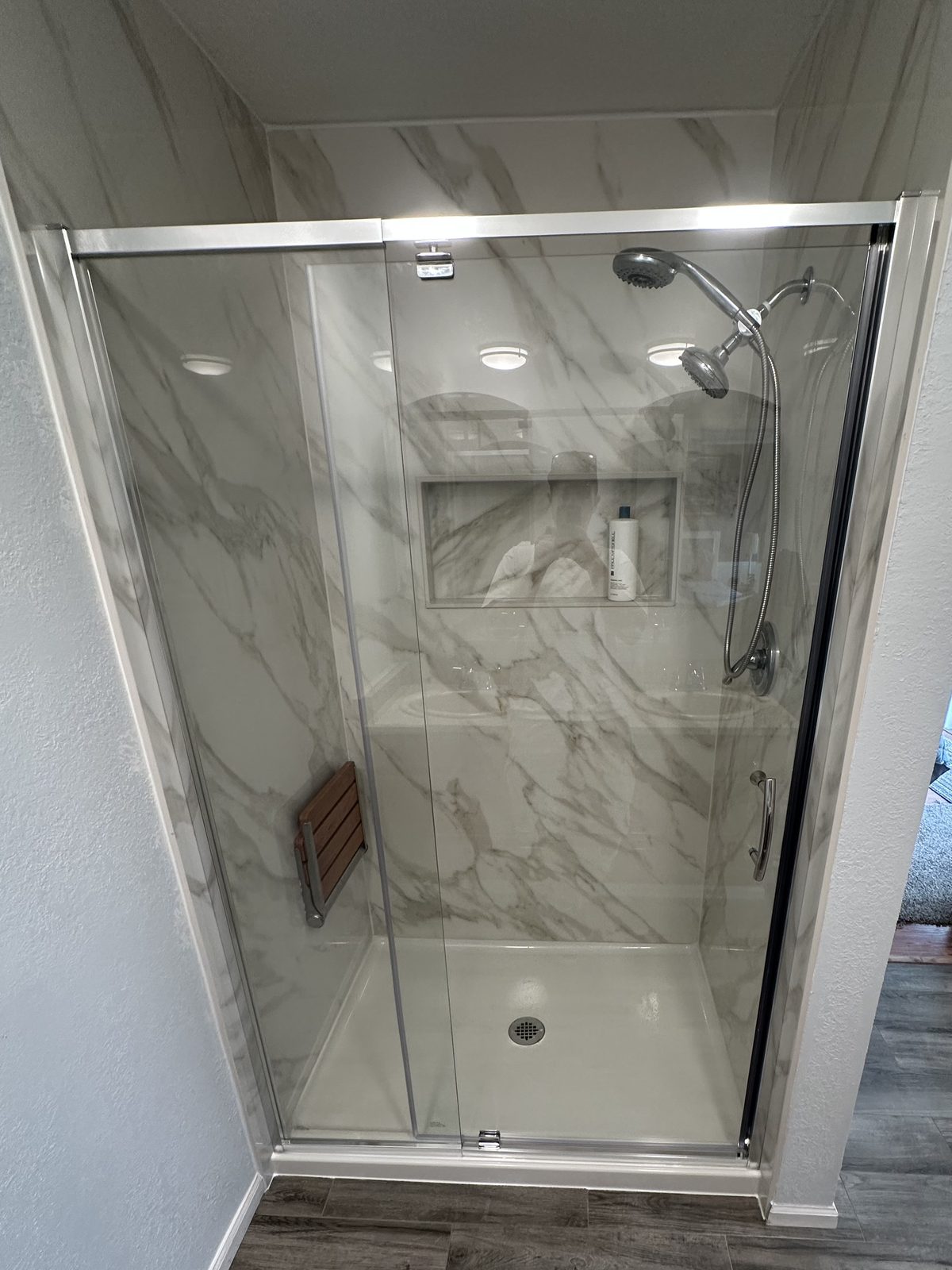 Quartz walls and a glass door, in a two week turnaround. Shower remodel in Tacoma by DA Interior Solutions