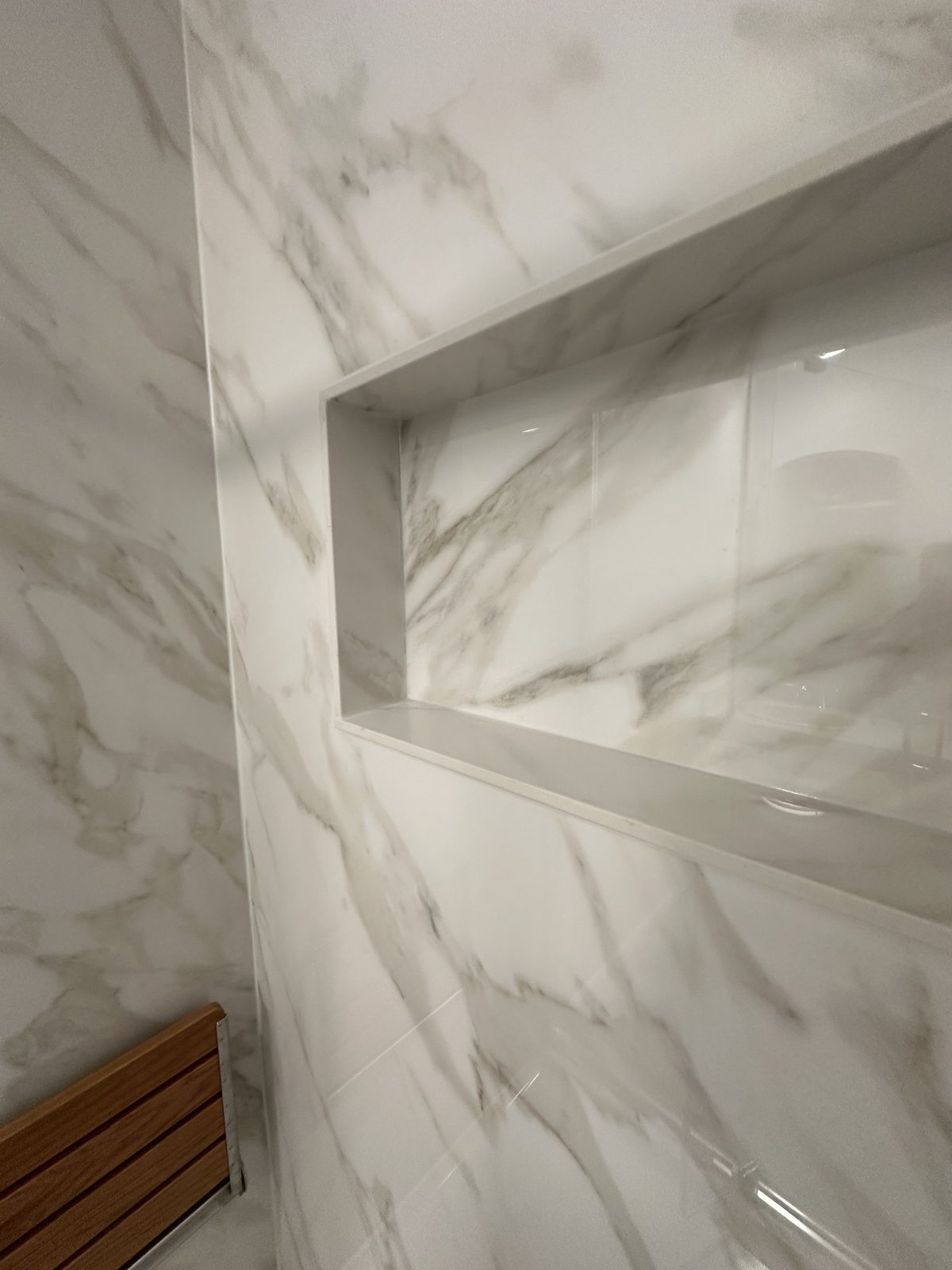 The niche, wrapped in the same slab as the walls. Shower remodel in Tacoma by DA Interior Solutions