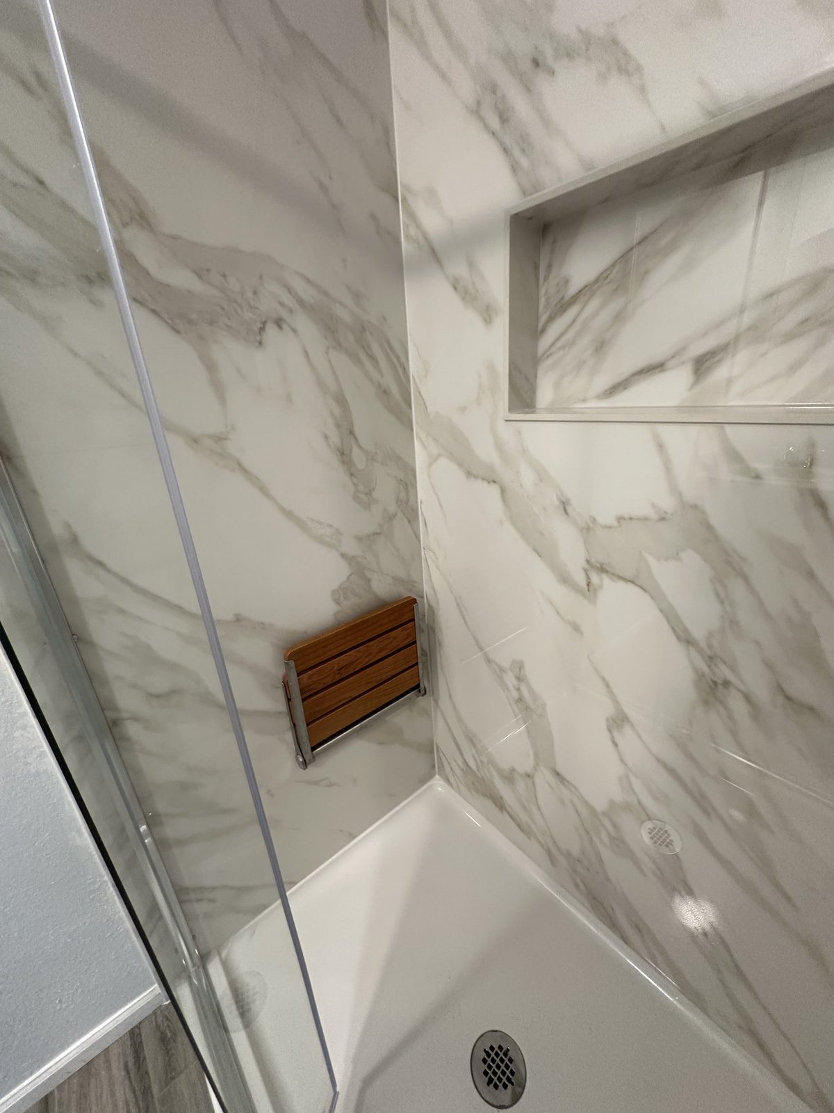 No grout line inside the wet area. Shower remodel in Tacoma by DA Interior Solutions